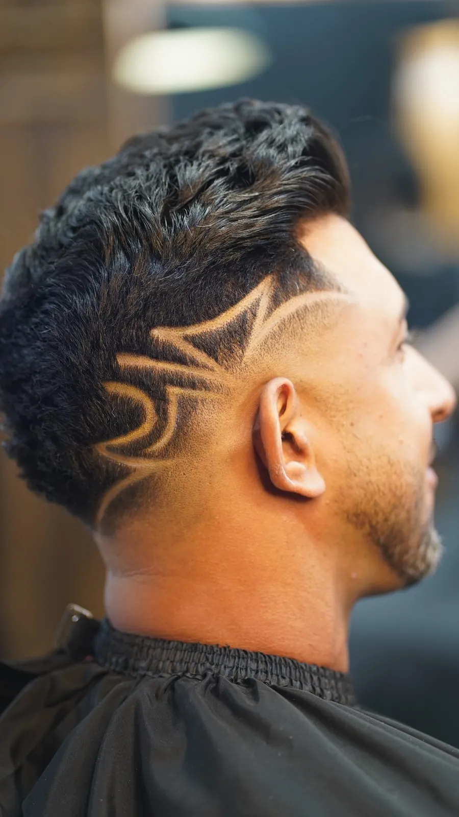 Geometric design shaved into the side of a textured fade