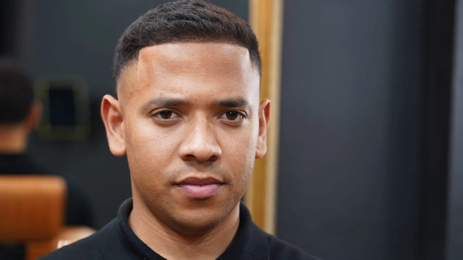Client with a low skin fade and short textured hair