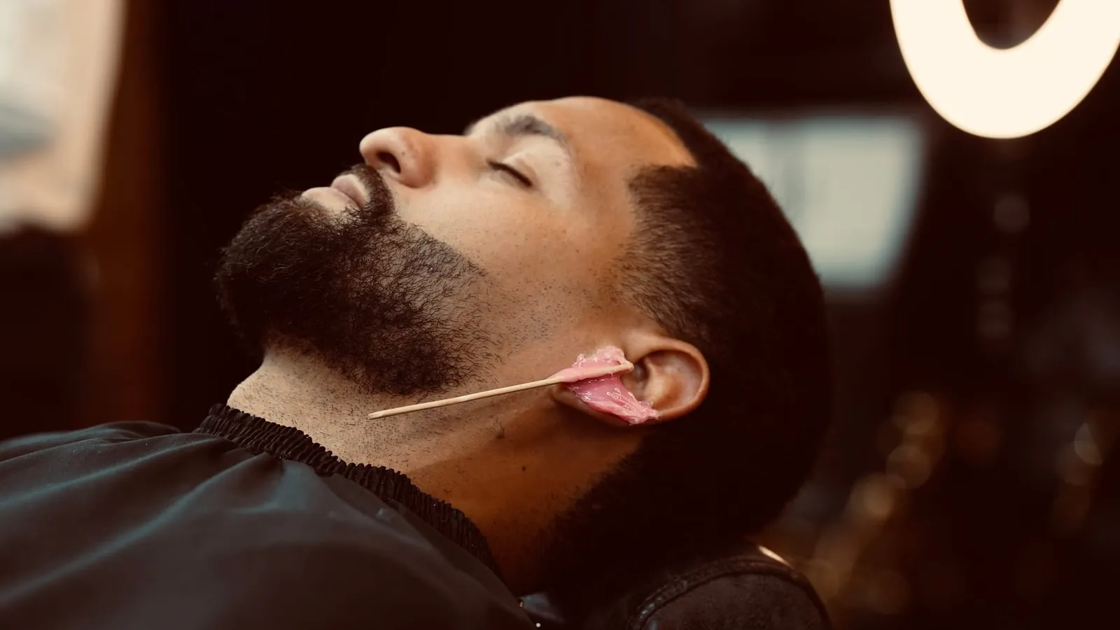 Wax on a reclining client's ear