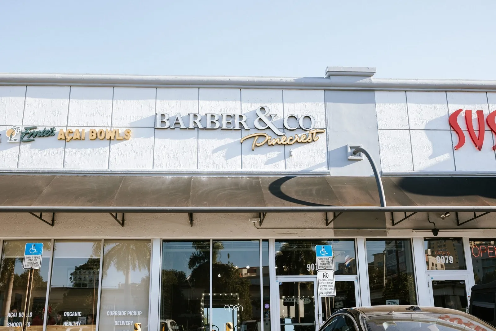 Barber & Co Pinecrest storefront sign above the shop windows