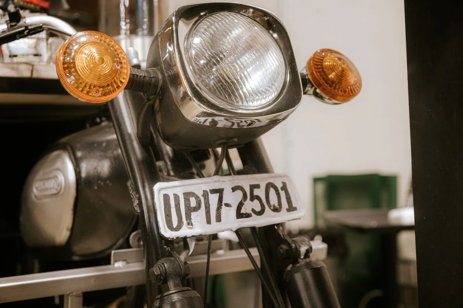 Vintage motorcycle headlight displayed inside the shop