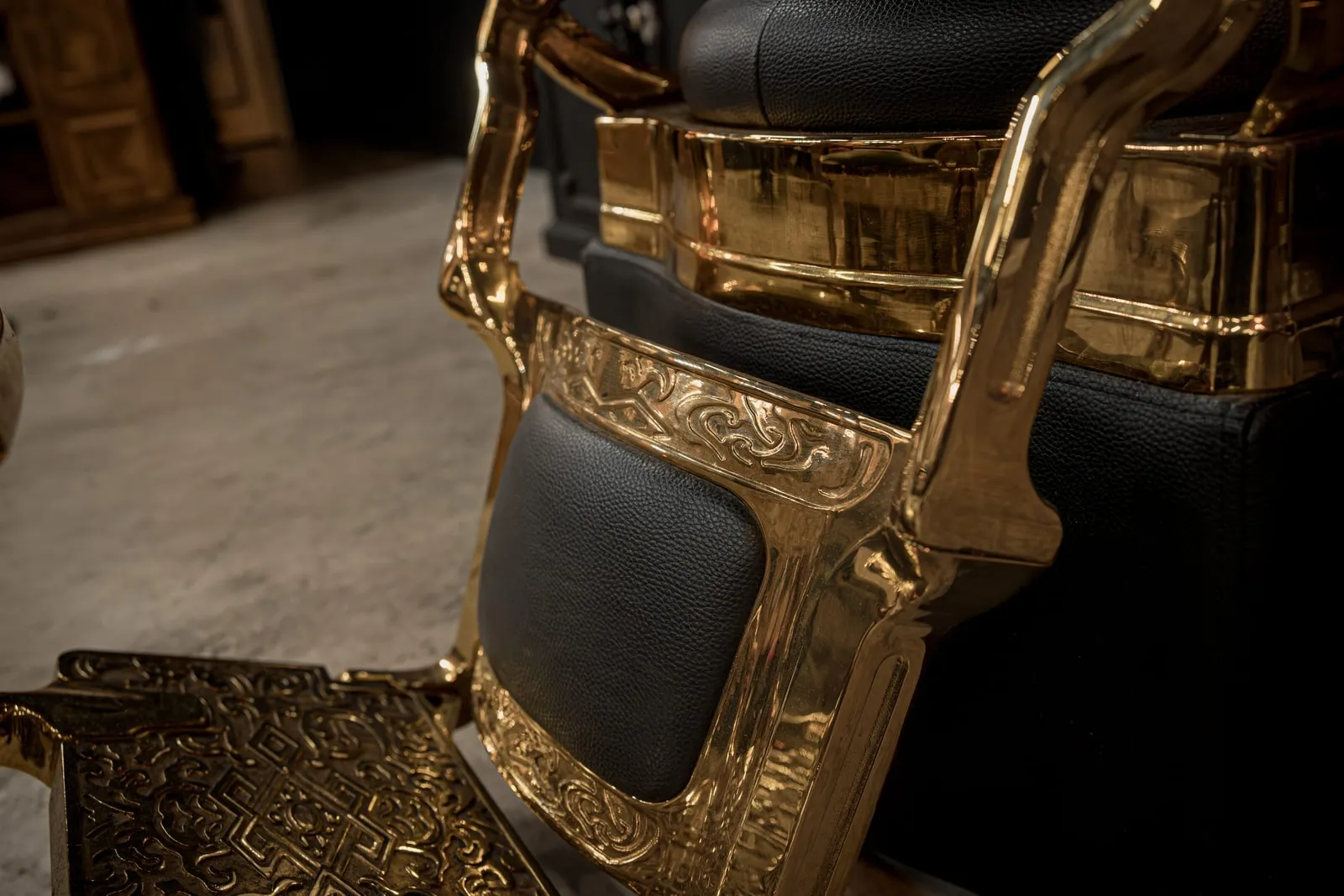 Ornate gold and black leather barber chair