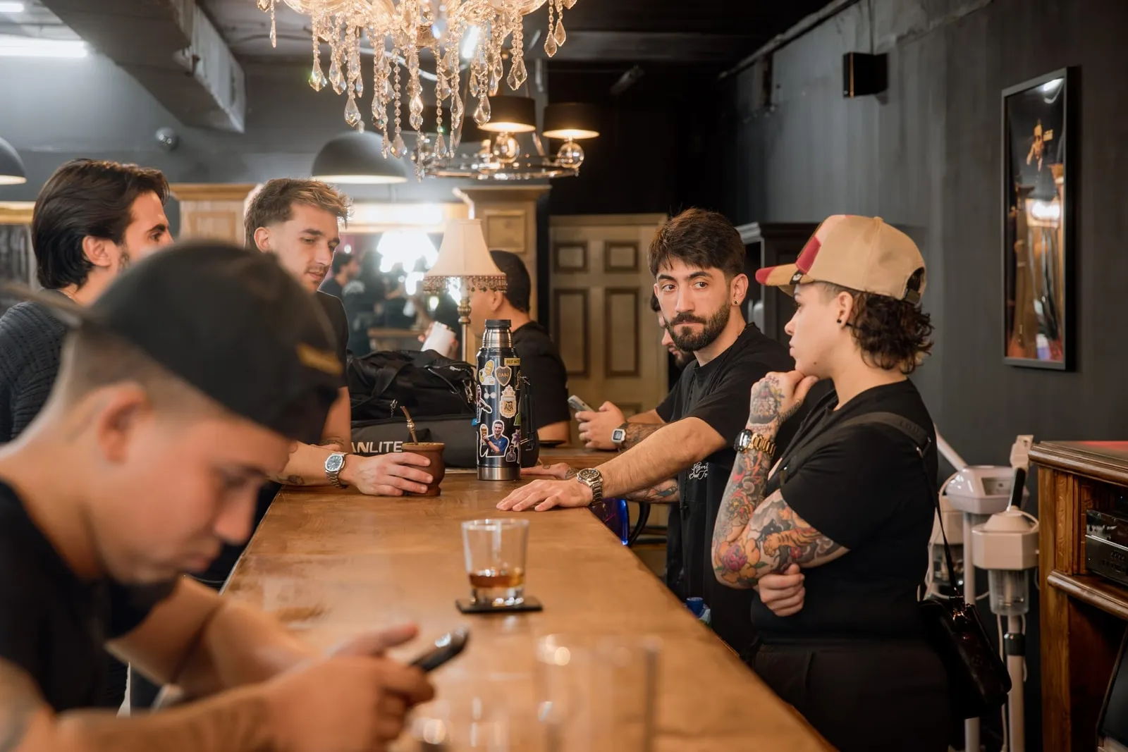 People gathered around the wood bar in the shop