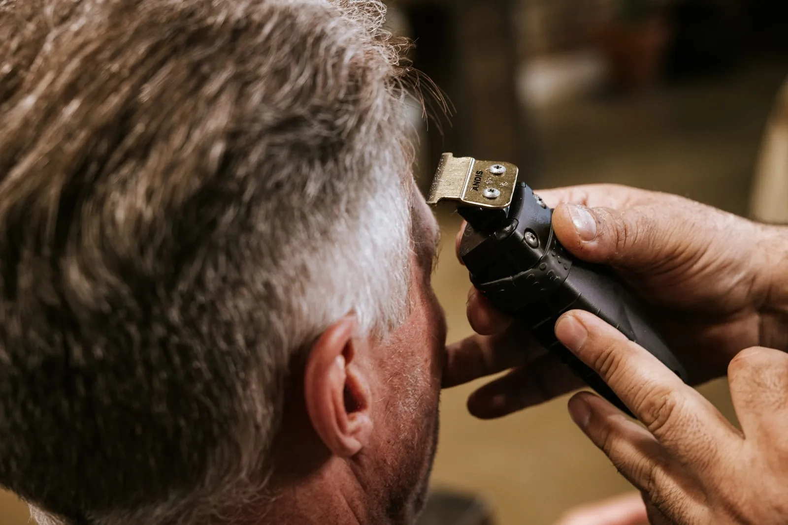 Clippers blending the side of a client's gray hair