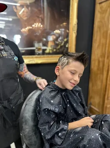 Boy's spiked haircut with a shaved design on the side