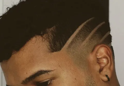 Custom hair design shaved into a fade
